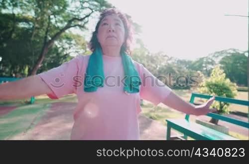 Asian elderly couple doing warm up exercise before work out inside the park, recreation playground, family get together, healthy activities body conditioning, senior group exercise community