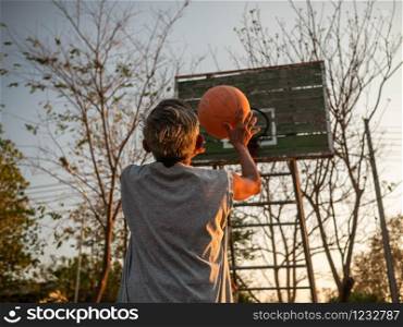Asian elderly men playing basketball on playground on summer day. Healthy lifestyle and Healthcare concept.