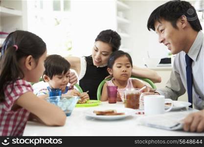 Asian Family Having Breakfast Before Husband Goes To Work