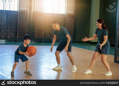 Asian family playing basketball together. Happy family spending free time together on holiday