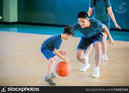 Asian family playing basketball together. Happy family spending free time together on holiday