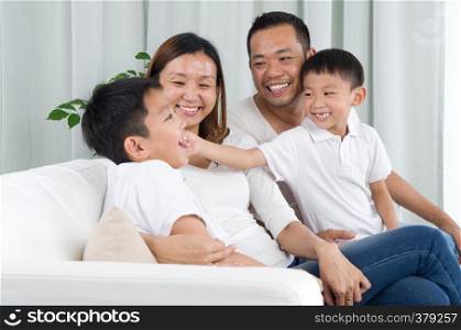 Asian family playing on sofa