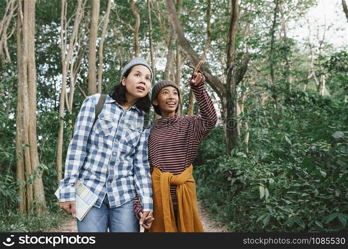 Asian family with a mother and daughter traveling to study the natural path. The concept of family tourism holiday lifestyle.