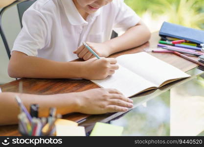 Asian father helps son to do her homework for the school.
child study together homeschooling concept getting homework help from father.