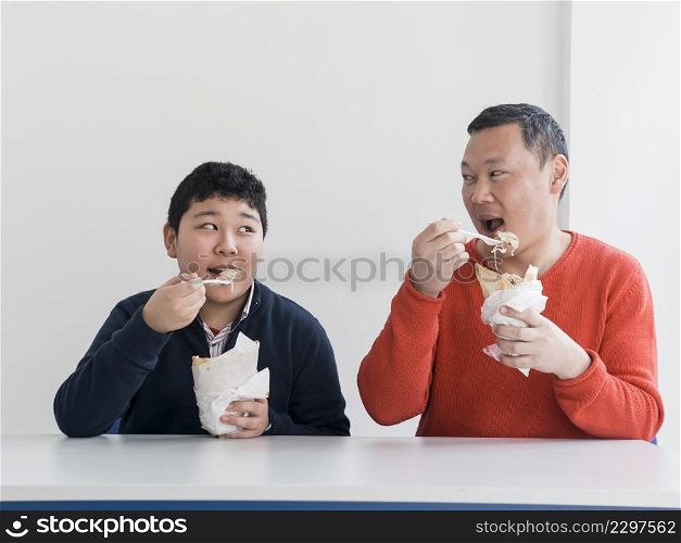 asian father son eating fast food