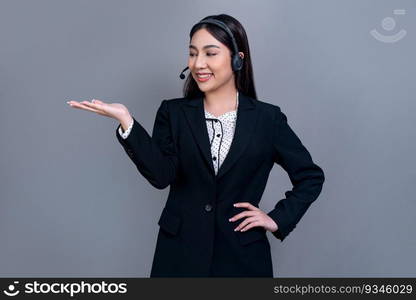 Asian female call center operator with happy smile face advertises job opportunity on empty space, wearing formal suit and headset on customizable isolated background for job recruitment. Jubilant. Attractive Asian operator with formal suit and headset. Jubilant