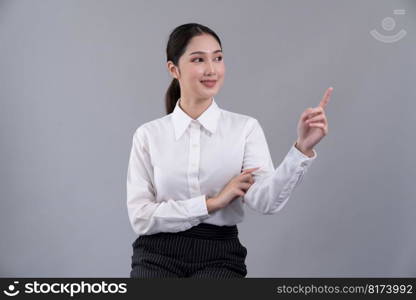 Asian female call center operator with smile face advertises job opportunity, wearing a formal suit and headset pointing finger for product on customizable isolated background. Enthusiastic. Asian operator wearing formal suit and headset with pointing finger Enthusiastic