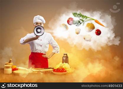 Asian female cook holding megaphone. Asian female cook holding megaphone vegetables flying in air