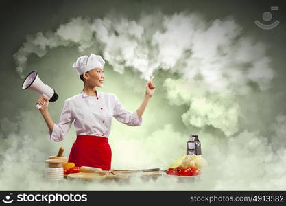 Asian female cook holding megaphone. Asian female young cook smiling holding megaphone