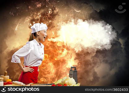 Asian female cook in anger against color background with shine effects