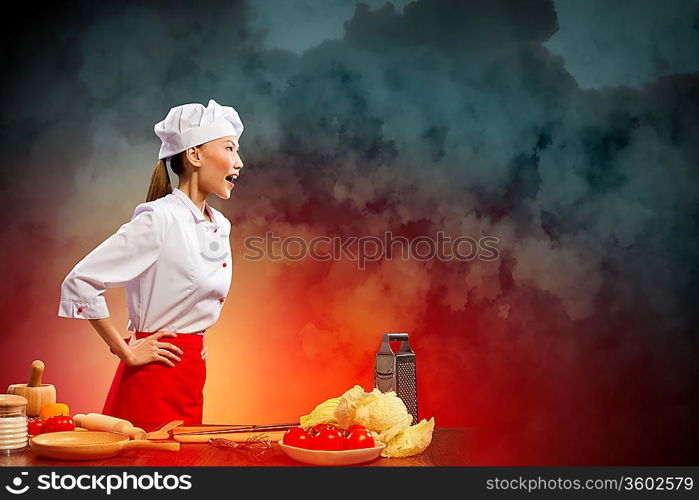 Asian female cook in anger against color background with shine effects