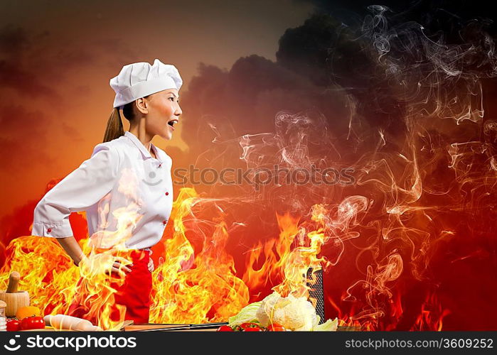 Asian female cook in anger against color background with shine effects