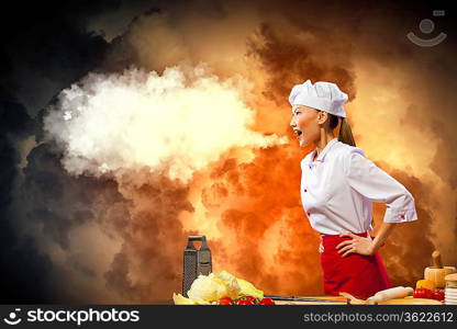 Asian female cook in anger against color background with shine effects