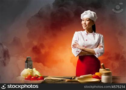 Asian female cook in anger. Asian female cook in anger against color background with shine effects