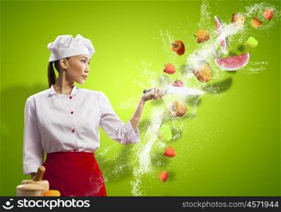 Asian female cook with knife. Asian female cook with knife cutting fruits and vegetables in air