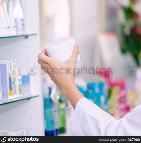 asian female pharmacist in the pharmacy and medicine in holding hand health care concept in Thailand