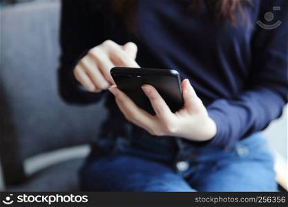 Asian female with hands typing text message