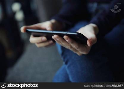 Asian female with hands typing text message