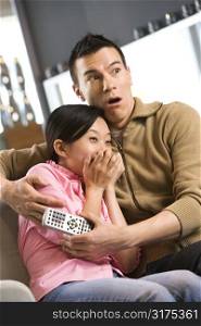 Asian female with scared expression while Asian male comforts her.