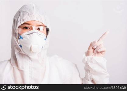 Asian female woman doctor or nurse in PPE uniform and gloves wearing face mask protective in the laboratory pointing finger to side space, Health medical coronavirus or COVID-19 concepts