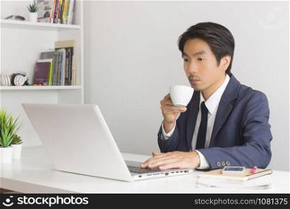 Asian Financial Advisor or Asian Consulting Businessman Drinking Coffee in Break Time. Asian Businessman in relax time