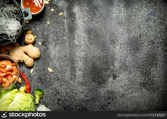 Asian food. A variety of ingredients for cooking Chinese or Thai food on a rustic background .