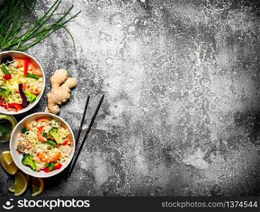 Asian food. Chinese noodles with vegetables. On rustic background .. Asian food. Chinese noodles with vegetables.