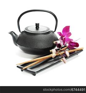 Asian food concept (Tea pot, orchid and chopsticks)