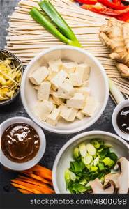 Asian food ingredients: tofu, noodles, ginger, cut vegetables, Sprout,green onion and hoisin sauce for tasty cooking, top view
