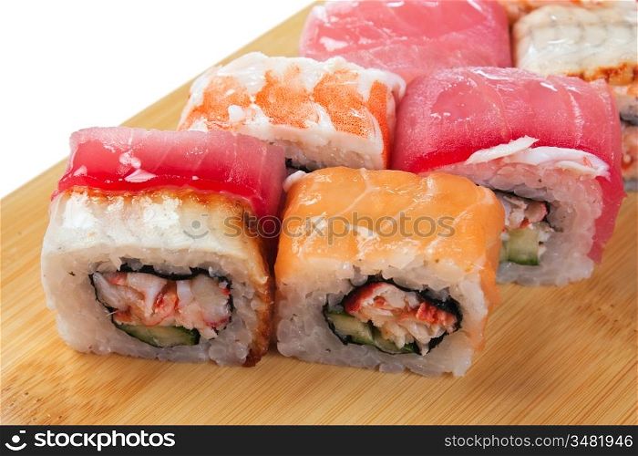 Asian food sushi on wooden plate isolated on white background