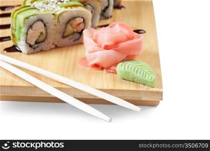 Asian food sushi on wooden plate isolated on white background