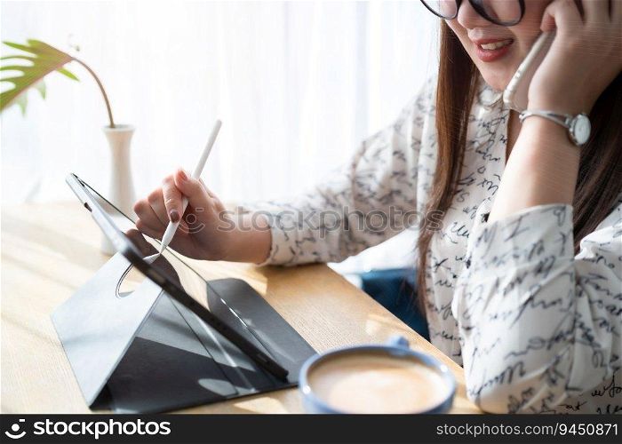asian freelance people business female talking making using smartphone working with taking note on digital tablet with electronic pen for browsing internet chatting and blogging with coffee cup.