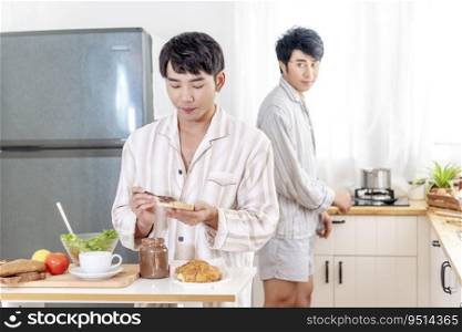Asian gay couple homosexual cooking together in the kitchen prepare fresh vegetable make organic salad healthy food. Asian people happy time smile, laugh in kitchen. LGBTQ relation lifestyle concept