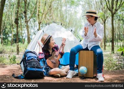 Asian girl and mother playing music in outdoors forest. People and lifestyles concept. Nature and Travel theme.