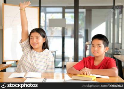 asian girl boy student studying raising hand in classroom. learning education at school