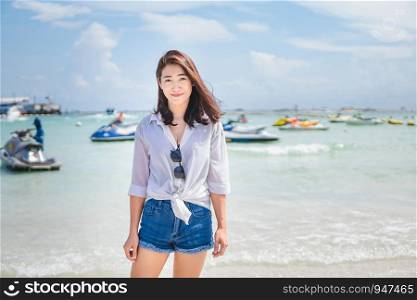 Asian girl enjoying her vacation by the sea