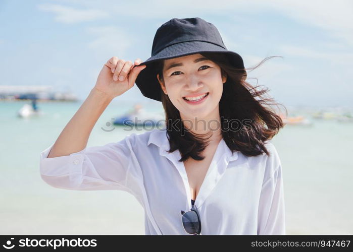 Asian girl enjoying her vacation by the sea