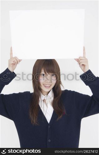 Asian girl holding white sign