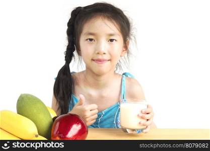 Asian girl is drinking a glass of milk over white background