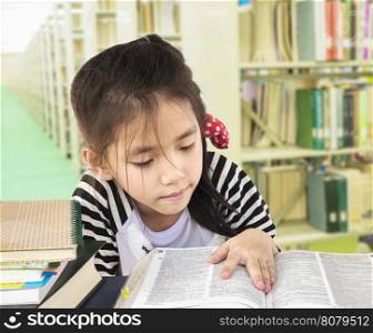 Asian girl is reading book in a library