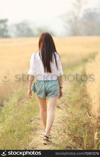 Asian girl on wheat field