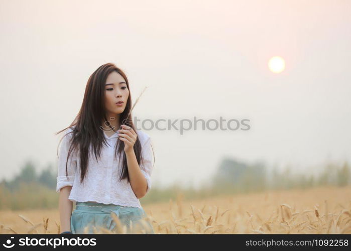 Asian girl on wheat field