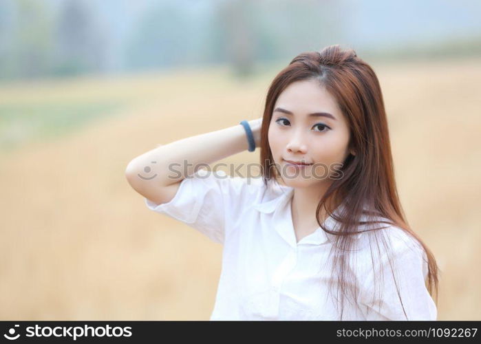 Asian girl on wheat field