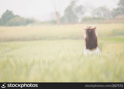 Asian girl relax on wheat field