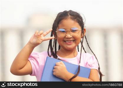 Asian girl smiles happily as school reopens after COVID-19 improves