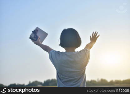 Asian Girl standing hold gift box to sky