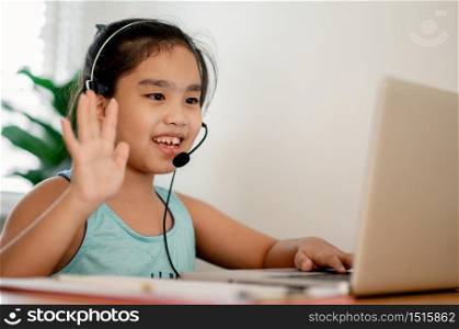 asian girl student wear headphone watch webinar listen online course communicate by conference video call. . Homeschooling and distance learning ,online ,internet protect from COVID-19 viruses.