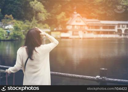 Asian girl tourists are happy by the lake in Fukuoka. Pic was taken in Oetober 2017.