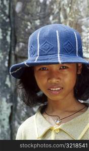 Asian Girl Wearing Hat and Looking at You