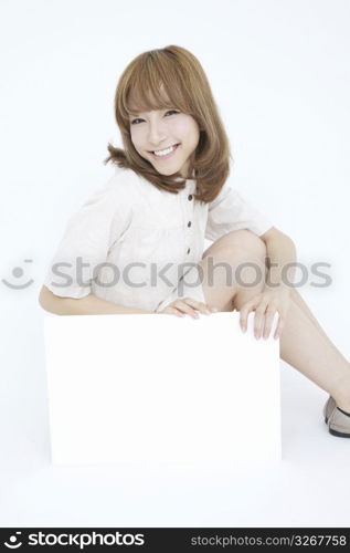 Asian girl with white sign